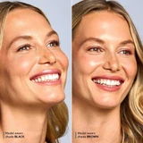 Smiling model wearing Total Lash Mascara in shades Black and Brown