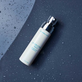 Hydrating Mist bottle on a dark blue surface with water droplets