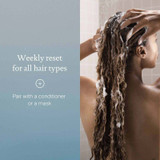 Woman lathering shampoo in her hair, weekly reset for all hair types