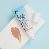Water Drench Sheer Tint SPF 45 tube beside light brown tinted cream smear