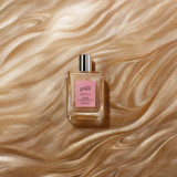 amazing grace intense luminous body oil bottle on gold shimmer surface