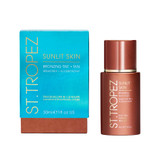 Sunlit Skin bronzing tint bottle beside teal and orange carton