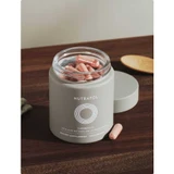 Open Nutrafol +Longevity jar filled with softgels on a wooden table