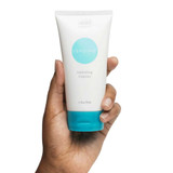 Hand holding Obagi360 Exfoliating Cleanser tube