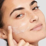 Model applying Dermalogica Active Moist lotion to cheek