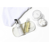 epionce Milky Lotion Cleanser with cotton rounds on a white tray