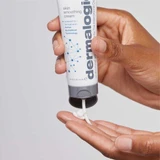 Hand squeezing Dermalogica Skin Smoothing Cream into palm