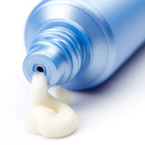 Cream squeezing from the open tube