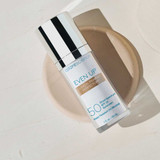 Even Up SPF 50 bottle resting on a beige dish