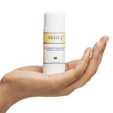Hand holding Obagi-C Fx C-Therapy Night Cream bottle