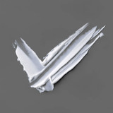 Thick white cream swipes on a gray background