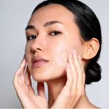 Woman washing her face with cleanser foam