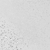 Close-up of fine water droplets on a pale surface, mist texture