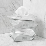 Stack of Obagi cleansing wipe packs on marble