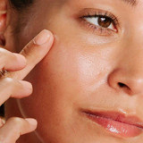 Close-up of a woman touching her cheek