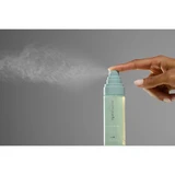 Finger spraying a fine cloud from the HydraFlora Mist bottle