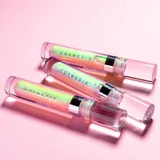 Three Cosmedix Lumi Crystal lip tubes on a pink background