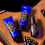 Jack Black Beard Wash, Beard Lube and Beard Oil on a wooden table with dominoes