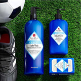 Jack Black Turbo Wash pump bottles and bar soap on artificial turf with a soccer ball