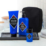 Jack Black All-Over Wash, body lotion and travel bottle beside a black toiletry bag