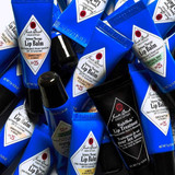 Pile of Jack Black Intense Therapy Lip Balm tubes in assorted flavors