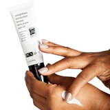 Hands squeezing PCA Weightless Protection SPF 45 onto a forearm