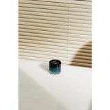 Hard Water Pomade jar on a table in window light