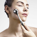 Woman using the ReFa O Style roller on her cheek