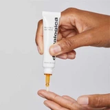 Hand dispensing BioLumin-C Eye Serum onto a fingertip