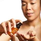 Woman dispensing Acne Gel into her palm