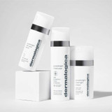 Three Dermalogica PowerBright products arranged on white blocks, serum in front