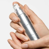 Hand holding a Dermalogica Smart Response Serum bottle