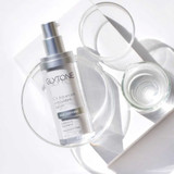 Glytone C+ serum bottle among clear glass dishes