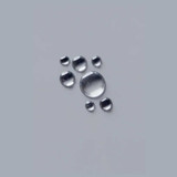 Clear water droplets on a gray surface