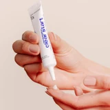 Hand squeezing cream from the Post-Breakout Fix tube onto a fingertip