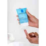 Hand squeezing Toleriane Double Repair Matte Moisturizer tube onto fingertip