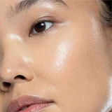 Close-up of dewy hydrated skin on a woman's cheek
