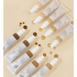 glo C-Shield Moisture Tint tubes in all shades scattered on beige