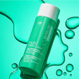 StriVectin Multi-Action Clear toner bottle on aqua background with water droplets