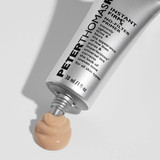 Primer tube squeezing out a swirl of peach primer