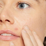 Woman touching her cheek, close-up