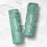 Two bottles lying among clear water droplets