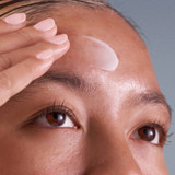 Close-up of serum applied to a woman's forehead