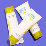 Three Clearing Defense SPF 30 tubes on a purple backdrop