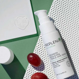 Replenix Redness Reducing Triple AOX Serum bottle with serum drop and red grapes