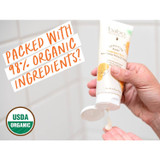 Hands squeezing the balm tube, packed with 98% organic ingredients graphic