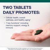 Hand holding two tablets with daily serving text
