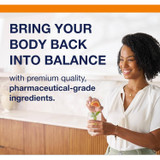 Smiling woman in a kitchen, Metagenics bring your body back into balance graphic