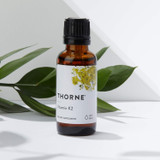 Thorne Vitamin K2 bottle beside green leaves