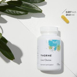 Thorne Liver Cleanse bottle with leaves and a capsule measuring 0.917 inches